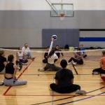 Students participating in seated volleyball at an adaptive intramural sports event. on January 9, 2025